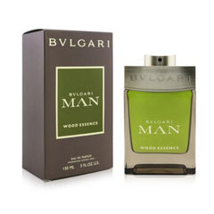 Bvlgari Man Wood Essence Eau de Parfum bottle and its dark brown packaging box, featuring an olive green liquid and metallic beige accents.