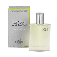 Hermes H24 Eau de Toilette bottle and its original packaging box, featuring a clear glass bottle with pale yellow liquid and a silver cap next to a gray box with a lime green edge.