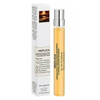 Maison Margiela Replica Eau de Toilette spray bottle and its white packaging box, featuring a light pink label and amber-colored liquid inside a clear bottle.