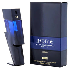 Carolina Herrera Bad Boy Elixir perfume bottle and packaging box. The bottle is a modern geometric shape in glossy dark blue and black, while the box is dark navy blue with a metallic blue band and white text.
