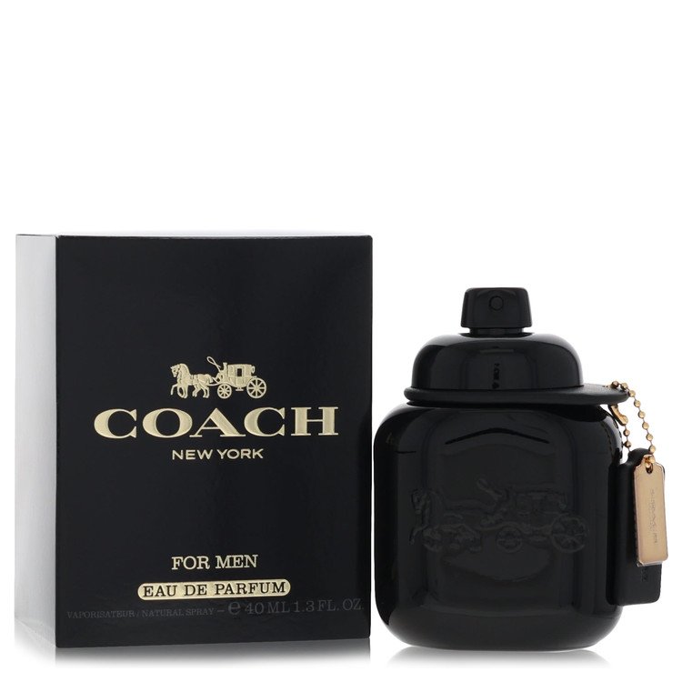 Coach New York For Men Eau De Parfum 140ml bottle in black with a gold hangtag, shown next to its black and white packaging box on a white background.