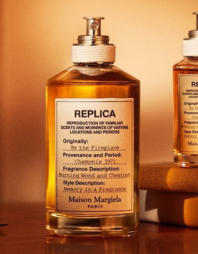 Two replica bottles on a wooden surface with a warm background