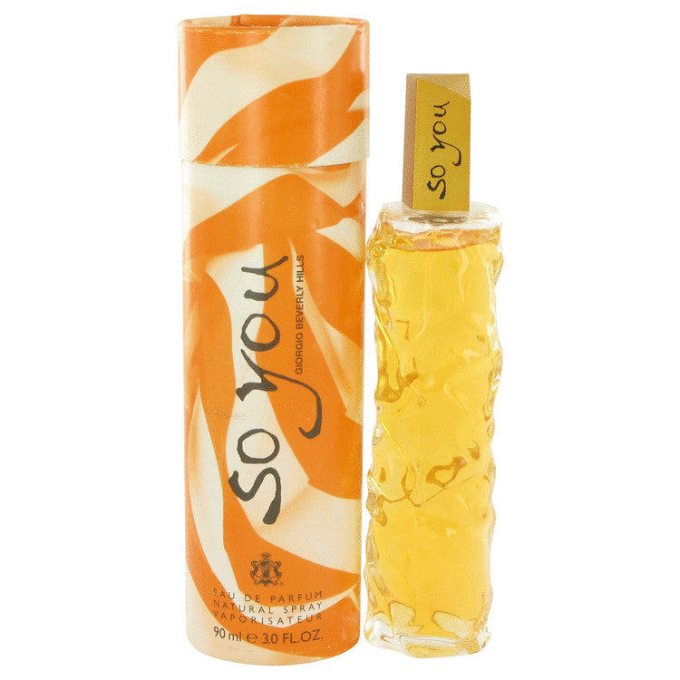 So You Eau de Parfum by Giorgio Beneditto, featuring a 30 ml textured clear bottle filled with golden-yellow liquid next to its orange and white patterned cylindrical packaging box.